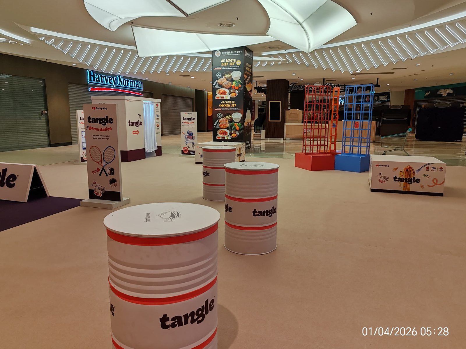 Samyang Cheese Buldak refuel-station roadshow with branded drum stools in a mall concourse